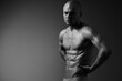 © SHOTPRIME STUDIO - Muscular man posing in a dramatic black and white scene, showcasing strength and determination with a powerful expression and artistic lighting.