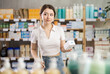 © JackF - Young woman buyer chooses box of pills in pharmacy
