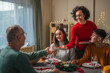 © Miljan Živković - Family enjoying christmas dinner together in warm dining room