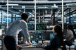 © DC Studio - Data center manager supervises engineer using AI visual programming to optimize gear. Server farm team leader overseeing work done by worker colleagues using artificial intelligence analysis software