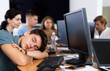 © JackF - During break between classes of computer courses, exhausted male student sits at table, puts head on crossed arms and sleeps