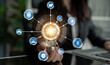 © InfiniteFlow - A professional hand holds a light bulb symbolizing innovation, with interconnected icons illustrating themes of security, technology, and business strategy in a digital landscape. Crux