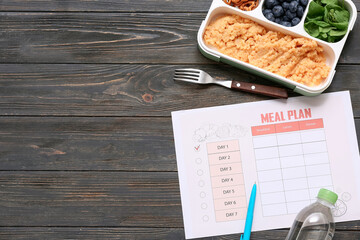 Wall Mural - Healthy products and weekly meal plan on wooden background. Diet concept