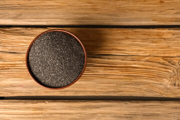 Wall Mural - Bowl with chia seeds on wooden background