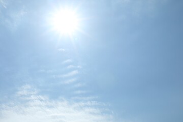 Wall Mural - bright sun and clouds on light blue sky. good weather