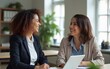 © li - They share a great office relationship. Shot of two smiling businesswoman sitting in an office talking together. High quality