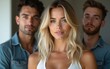 © lan - A beautiful young woman with blonde hair and two men behind her. High quality
