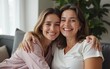 © hao - Beautiful mother and adult daughter hugging portrait close up, sitting on couch at home, smiling woman embracing mum, spending leisure time together, two generations good relationship. High quality