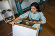 © Stock Latino - Latina woman unboxing new furniture for home improvement project