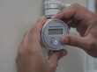 © SERHII - Indian man adjusting smart water meter for environmental conservation