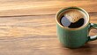 © Sudarat - Warm Green Coffee Mug on Rustic Wooden Table with Coffee Inside