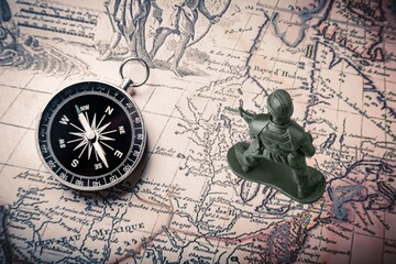  Little plastic toy army soldiers on map background