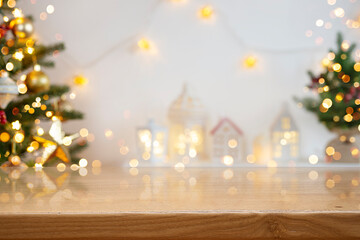 Wall Mural - Glossy wooden Christmas table top space on blurred room background decorated with colorful glowing holiday symbols
