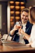 © bnenin - Smiling Couple Enjoying Drinks Together at a Cozy Restaurant Setting