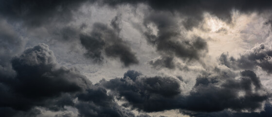 Wall Mural - Dark dramatic sky. Gloomy stormy cloudscape. Widescreen panoramic photo of a natural moody cloud background in anamorphic format with a 21:9 cinema aspect ratio