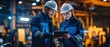 © Bog - The engineers collaborating on a tablet in a dynamic industrial setting.