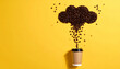 © Athiphat - Coffee bean cloud raining into takeaway cup, playful food art concept, yellow background, creative morning energy, caffeine inspiration, minimal style, cheerful mood