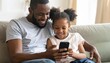 © Kim de Been - A young girl and her father looking at a mobile phone. Two generations learning technology together