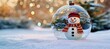 © Ilja - Festive snowman inside a glass ball ornament on a snowy background, capturing winter holiday spirit.