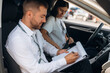 © standret - Side view. Woman is with instructor in car, driving school concept