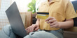 © Natee Meepian - Online Shopping: Woman using laptop and credit card for purchases at home