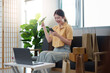 © Natee Meepian - Online shopping. Happy woman celebrating a successful purchase with smartphone.