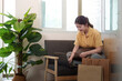 © Natee Meepian - Online Shopping. Young woman browsing laptop surrounded by shopping bags.