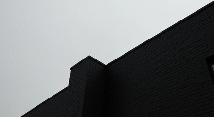 Black Brick Building Corner Against Grey Sky