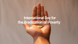 © shadeaatoine - Hand holding a coin with text 'International Day for the Eradication of Poverty'