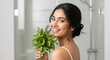 © PRASANNAPIX - close up of young indian woman holding mint leaf