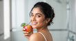 © PRASANNAPIX - close up of young beautiful indian woman holding fresh apple