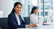 © ProArt Studios - Smiling young Indian business woman, an IT specialist, working o