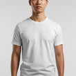 © Bayu - Casual model wearing white t shirt mockup with head cropped against plain clean background apparel branding