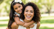 © Nur - Happy mother and daughter enjoying a sunny day outdoors family love bonding time together cheerful smiles happiness playful piggyback ride park nature