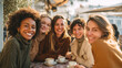 © Николай Чайка - Group of five diverse women enjoying coffee together at a cozy outdoor cafe, dressed in warm sweaters, sharing laughter and creating joyful memories in a vibrant atmosphere