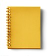 © Kawasan - A mustard-yellow spiral-bound notebook, closed, viewed from above on a white background