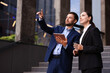 Coffee to go. Woman with paper cup of drink and her business partner during meeting outdoors, space for text