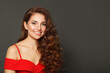 © artmim - Happy fashion model woman with shiny skin, wavy hairstyle and red lips makeup on black background