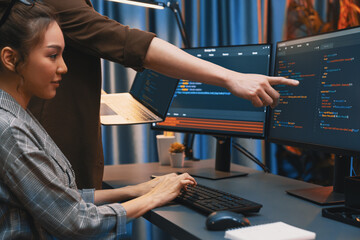 Serious of IT developers discussing intelligent website development coder system running data online two screens with laptop showing information network at neon light room at modern office. Infobahn.