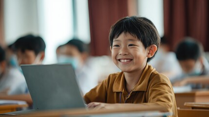happy smiling asian school boy using laptop computer at class in classroom smiling chinese junior school student learning online virtual education digital program app technology during tech lesson no