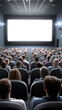 © Curioso.Photography - Full cinema hall with people watching bright screen.