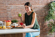© nenetus - Healthy woman having delicious breakfast while using smartphone in the kitchen at home