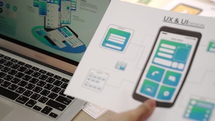 Panorama video of startup UX developer or company employee using laptop design user interface or UI prototype for mobile application or website software with software display on smartphone. Synergic