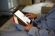 © Wavebreak Media - Mid adult African American man in grey business suit tapping tablet in office lounge, copy space