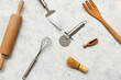 © Pixel-Shot - Set of different kitchen utensils with stainless steel pizza cutter on light background