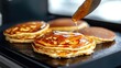 © Tujuenam - Golden syrup cascades down fluffy pancakes on a sizzling griddle tempting brunch delight
