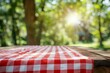 © sirirat - Empty Red and White Checkered Picnic Tablecloth with Blurred Green Park Background for Product Display and Advertising Mockup