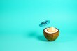© Fukuro - Tropical coconut drink with umbrella summer vacation concept on blue background studio shot for travel ads