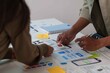 © itchaznong - Hands Collaborating on UX UI Design Prototypes