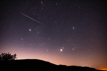 Wall Mural - Milky way stars, meteor trails and landscape silhouettes.